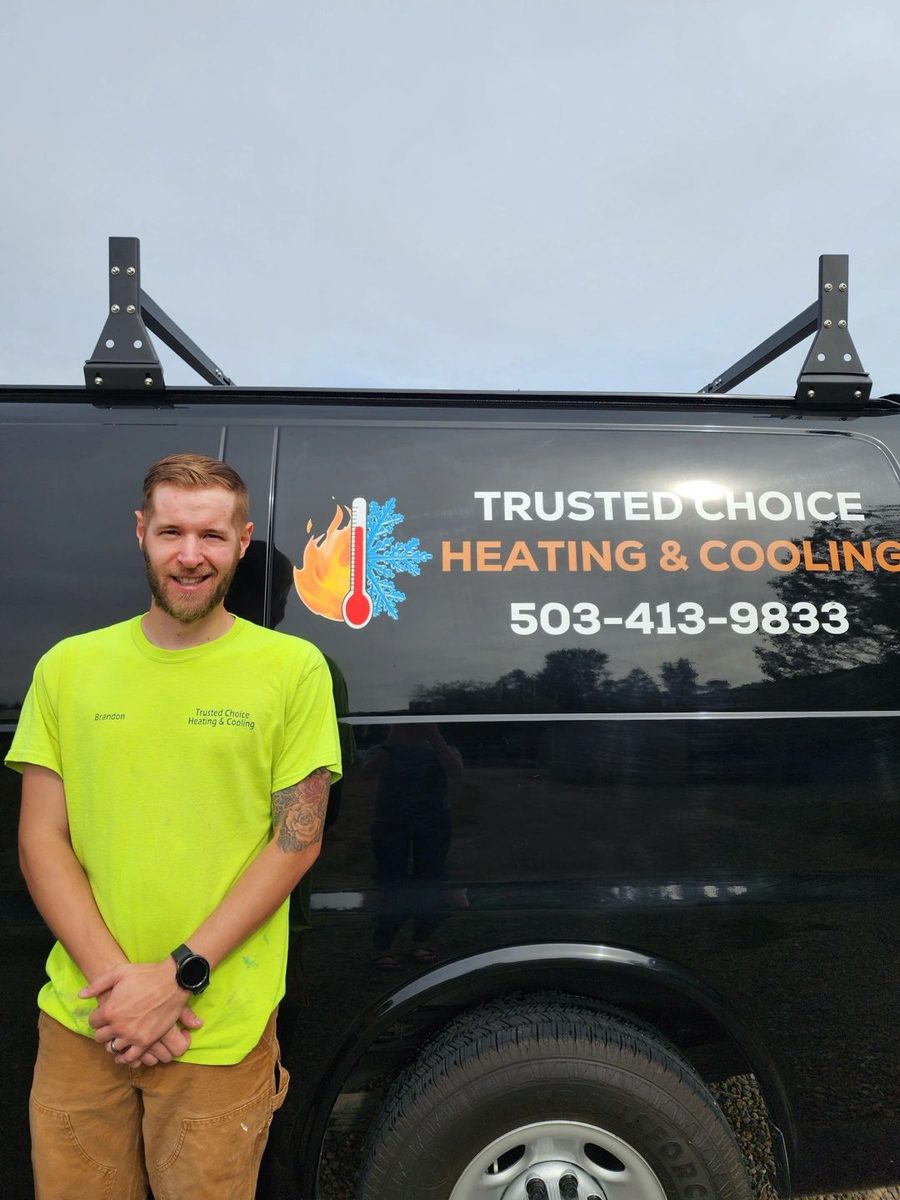 Brandon Haines, owner of Trusted Choice Heating and Cooling, standing beside his company van in Canby, Oregon